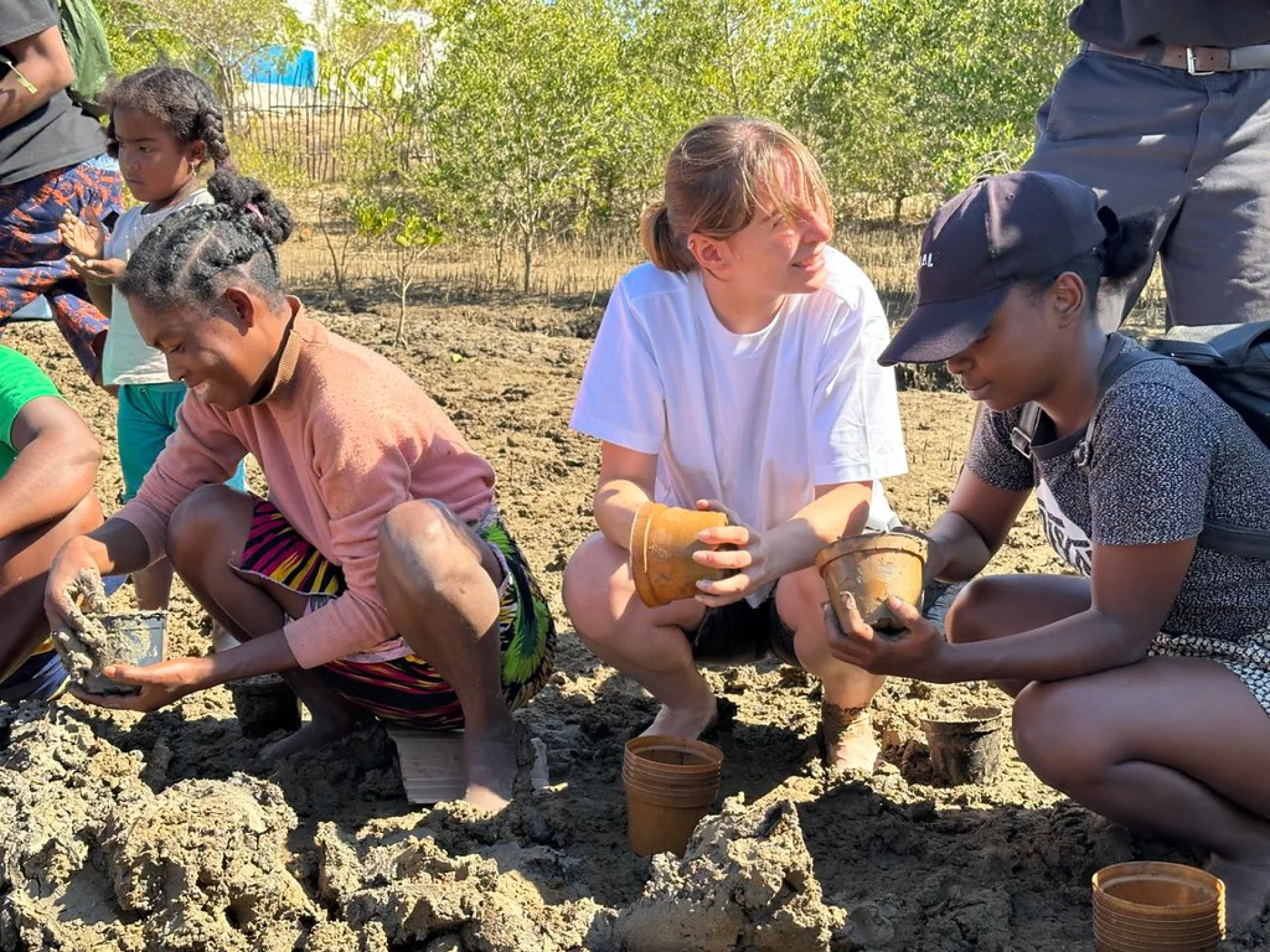 Solinatra team walking the Kimony mangrove planting site in western Madagascar, guided by Nicola Gandolfi of Tsiryparma