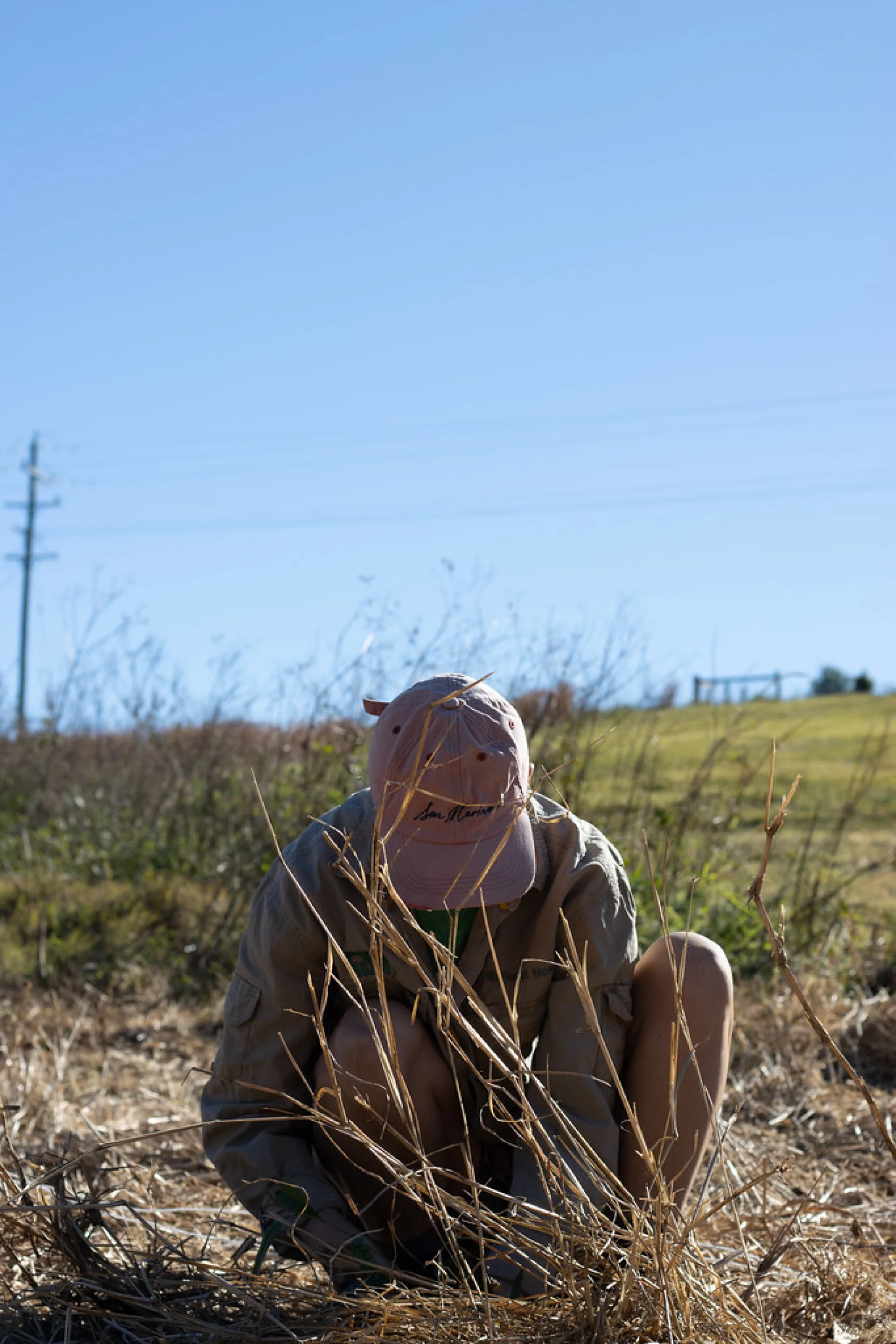A volunteer planting a native tree on a Queensland restoration parcel
